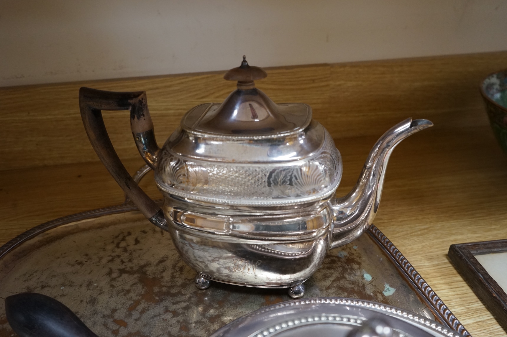 A pair of white metal candlesticks, a silver plated teapot circular tureen and cover spoons and forks and four spirit labels and large tray. Tray 73cm wide